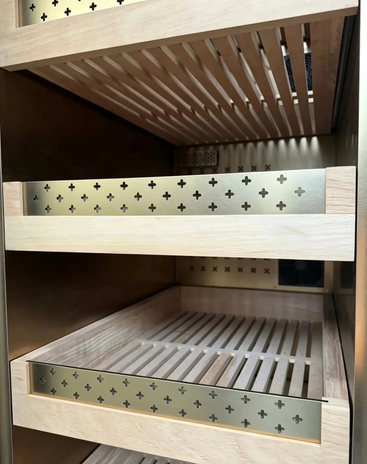 Illuminated twin-bay bespoke wine cabinet drawer interior detail